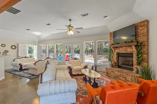 a living room with furniture fireplace and a flat screen tv
