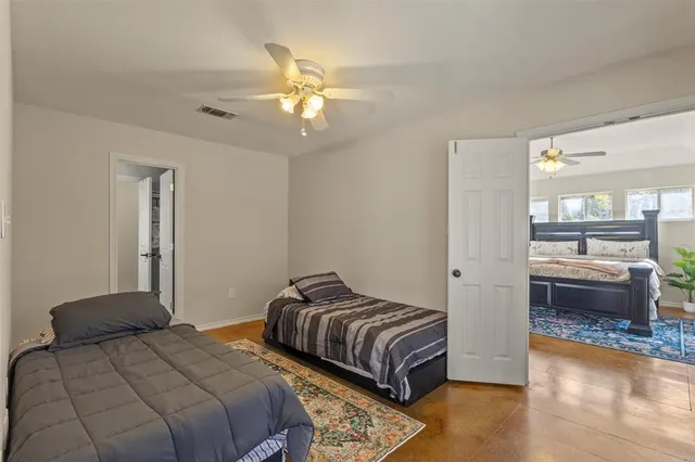 a bedroom with two beds and a chandelier