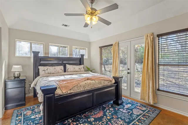 a bedroom with a bed and a chandelier