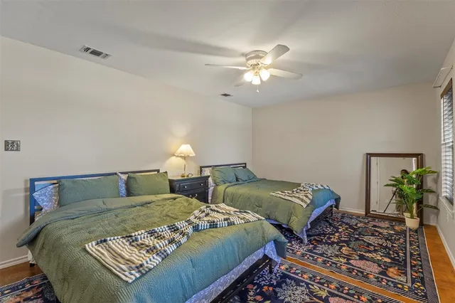 a bedroom with two beds and a chandelier
