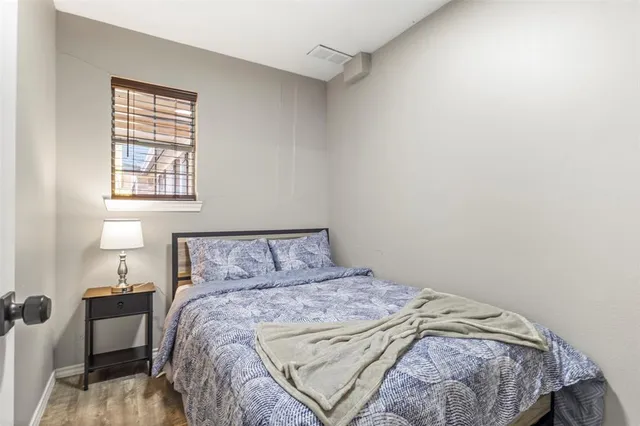 a bed sitting in a bedroom next to a window