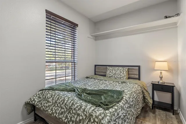 a bedroom with a bed and a window