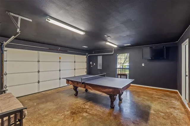 a room with pool table and window