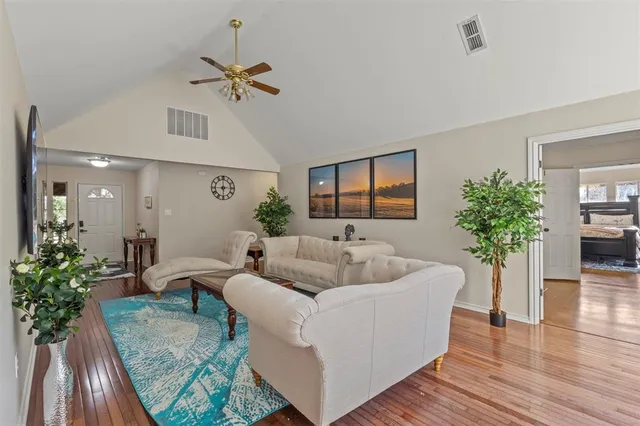 a living room with furniture and a potted plant