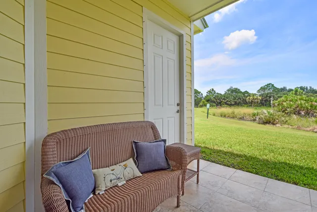 a view of a patio with a table and chairs