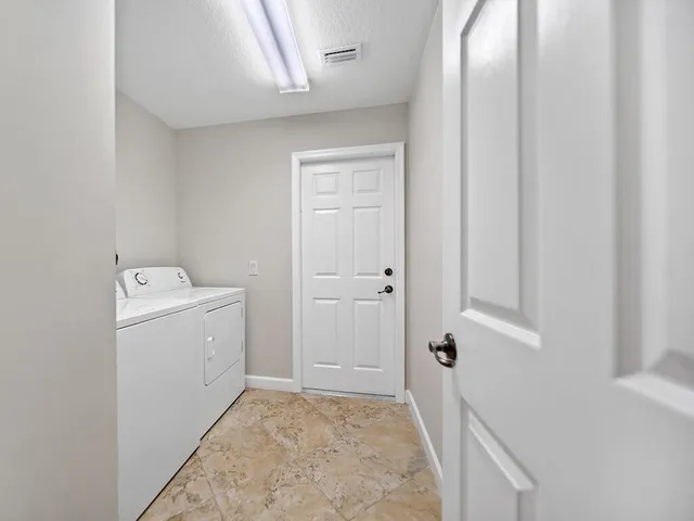 a view of a storage & utility room with a washer dryer
