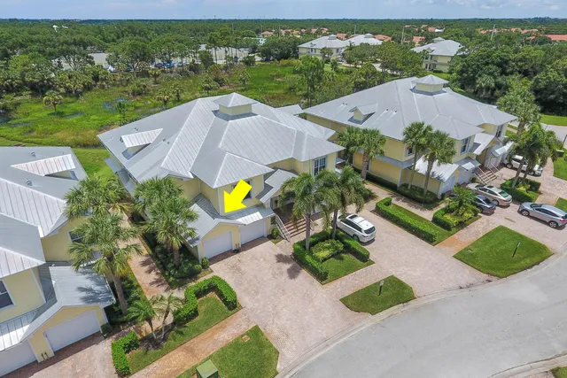 an aerial view of a house with a garden and lots of trees