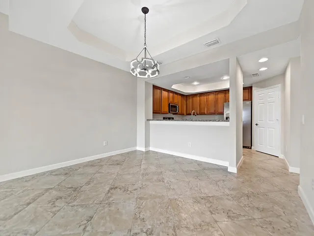 a view of a kitchen with a sink and a chandelier