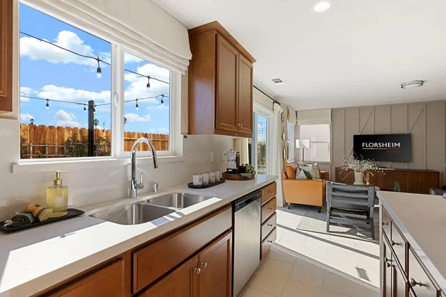 a kitchen with a sink and a stove top oven