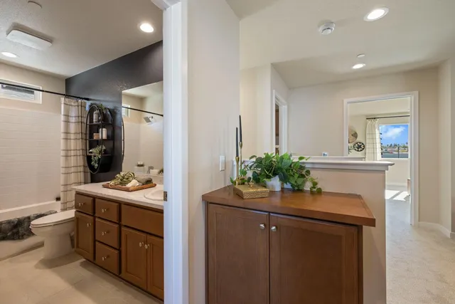 a bathroom with a sink vanity mirror and toilet