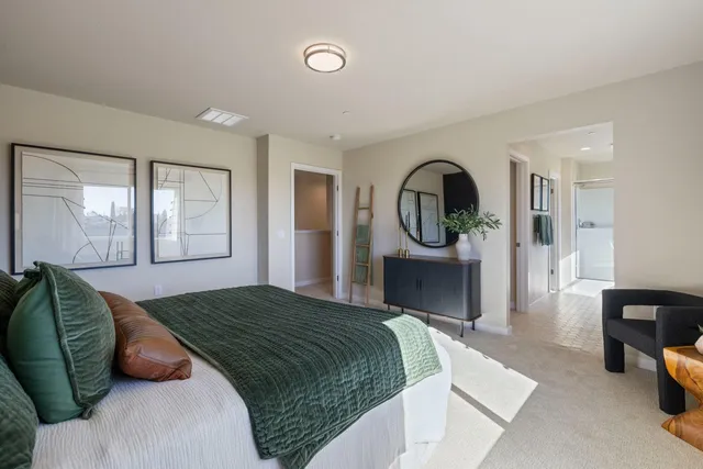 a bedroom with a bed mirror and window
