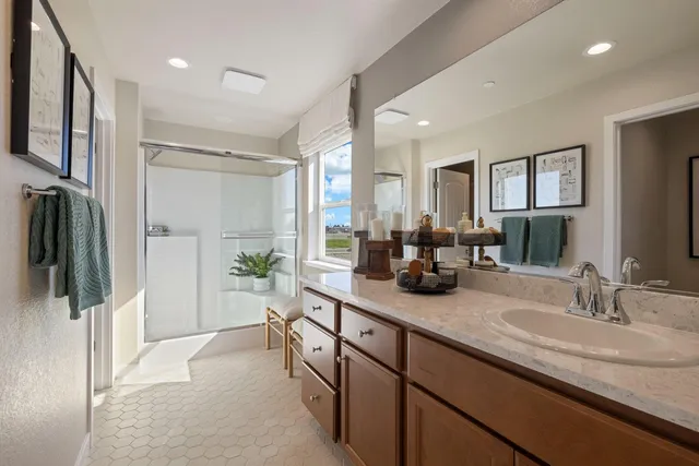 a bath room with double vanity sink and a mirror