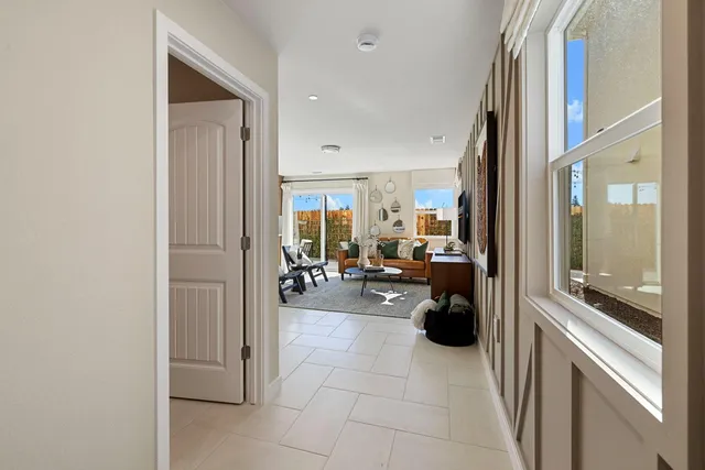 a view of a hallway with living room and couch