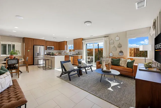 a living room with furniture and a view of kitchen