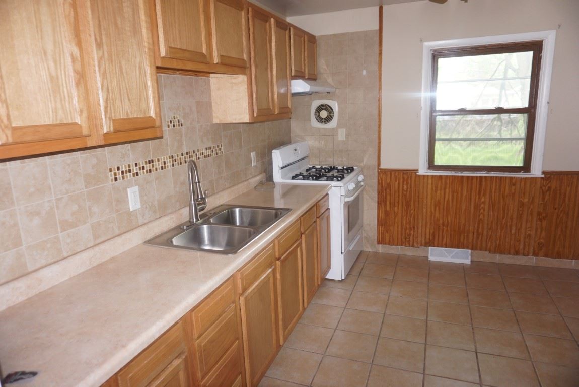 2105 North Alpine Road Rockford, IL 61107 - Photo 2 of 15 a kitchen with a sink stove and cabinets