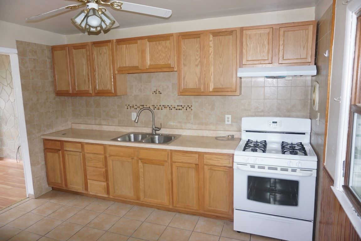 2105 North Alpine Road Rockford, IL 61107 - Photo 3 of 15 a kitchen with cabinets a sink and white stainless steel appliances