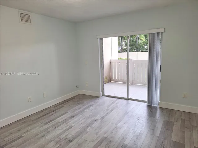 a bathroom with a granite countertop sink a toilet and a mirror