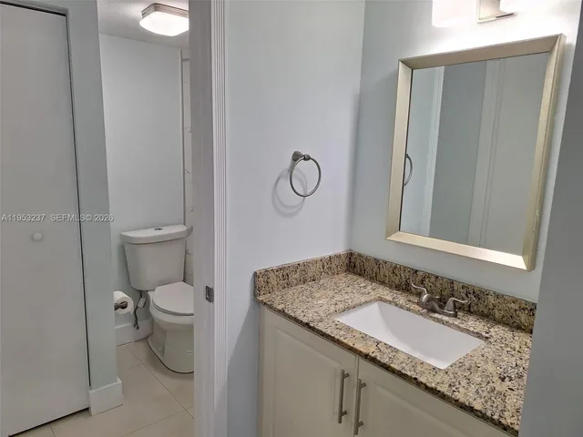 a white toilet sitting next to a bath tub