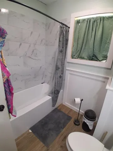 a bathroom with a toilet and a shower