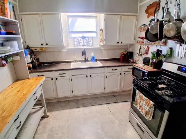 a kitchen with wooden cabinets and a stove top oven