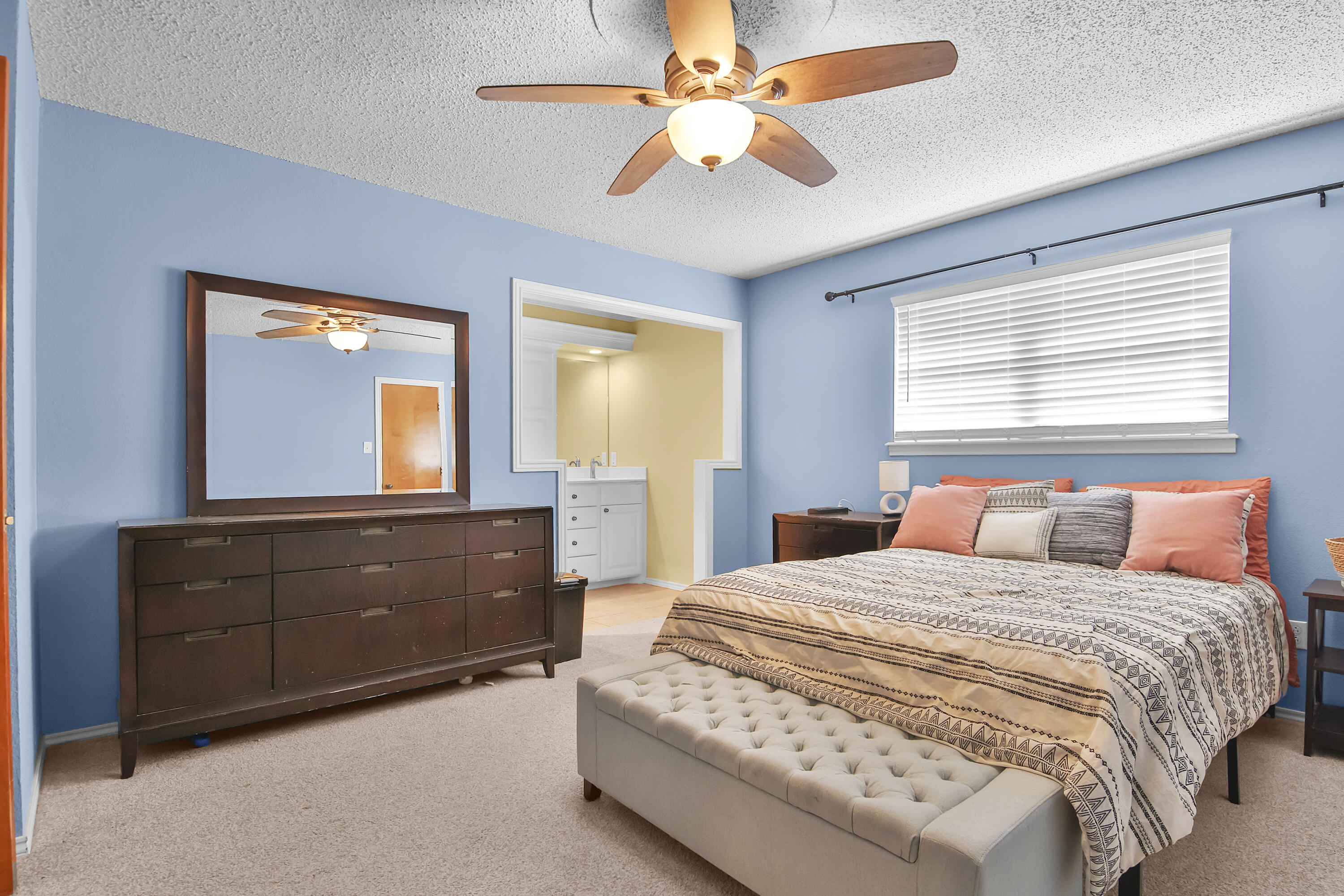 4805 73rd Street Lubbock, TX 79424 - Photo 14 of 26 a bedroom with a bed and a dresser