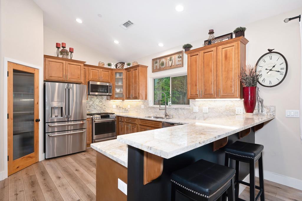 3960 Fort Jim Road Placerville, CA 95667 - Photo 20 of 64 a kitchen with stainless steel appliances a table chairs and a refrigerator