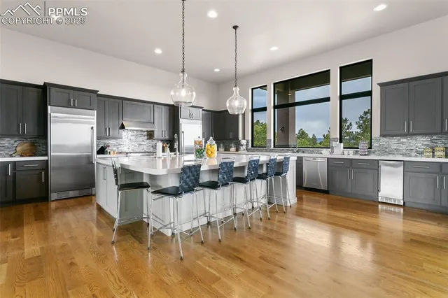 a kitchen with a sink cabinets and wooden floor
