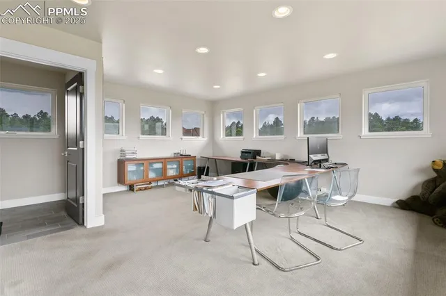 a view of a dining room with furniture a kitchen and chandelier