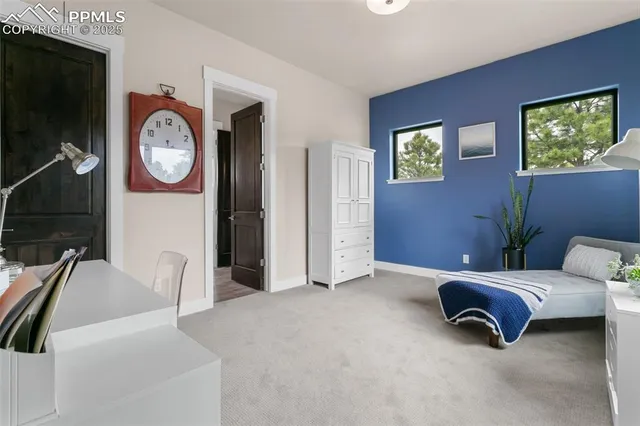 a living room with furniture and a wall painting