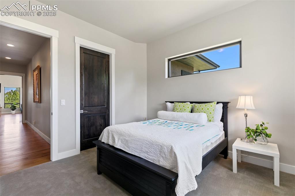 843 Long Timber Monument, CO 80132 - Photo 28 of 50 a bedroom with a bed table and a chair