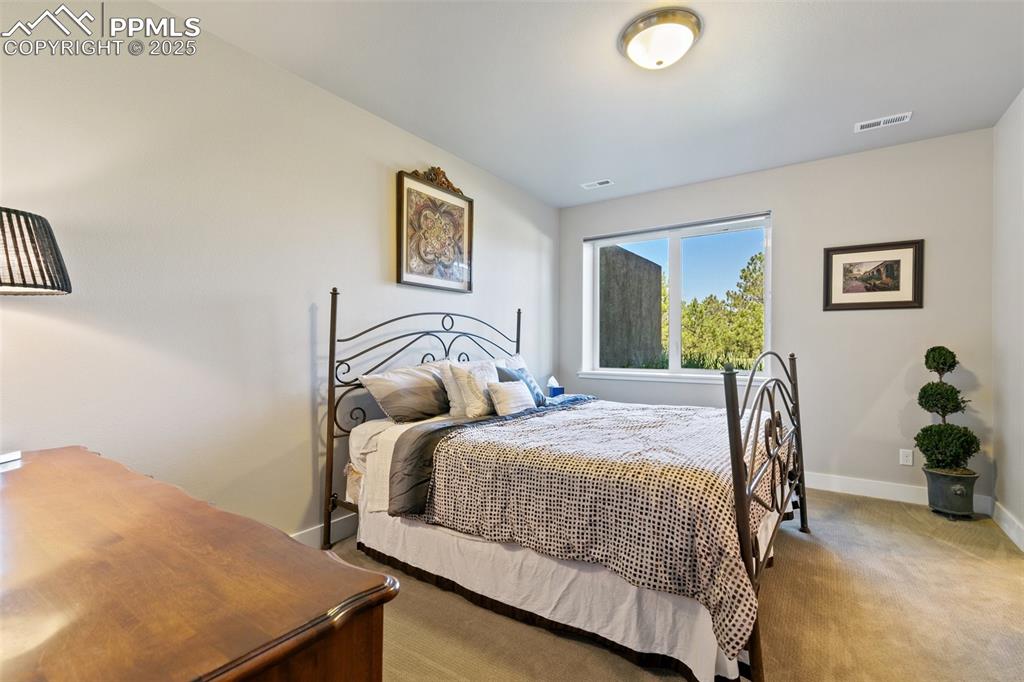 843 Long Timber Monument, CO 80132 - Photo 34 of 50 a bedroom with a bed and wooden floor