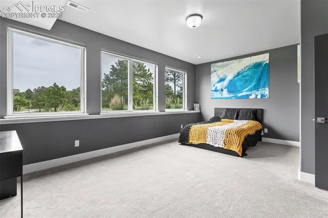 a bedroom with a large bed and a large window