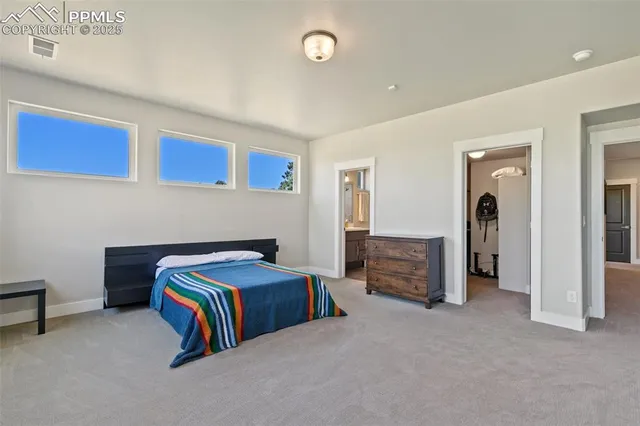 a bedroom with a bed and a desk