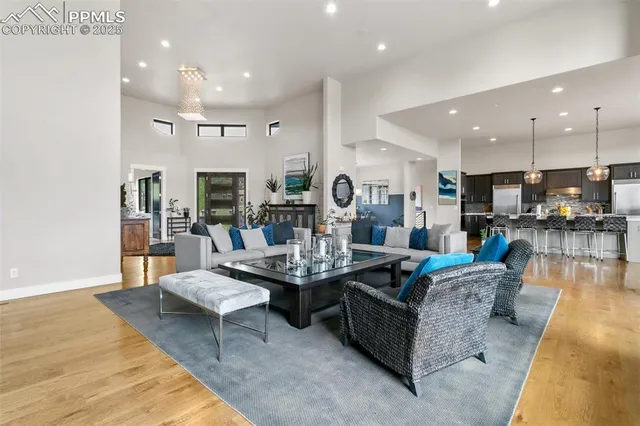 a living room with fireplace furniture and a wooden floor
