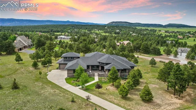 a view of a house with a yard and outdoor seating