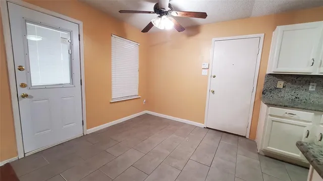 an empty room with closet and a window