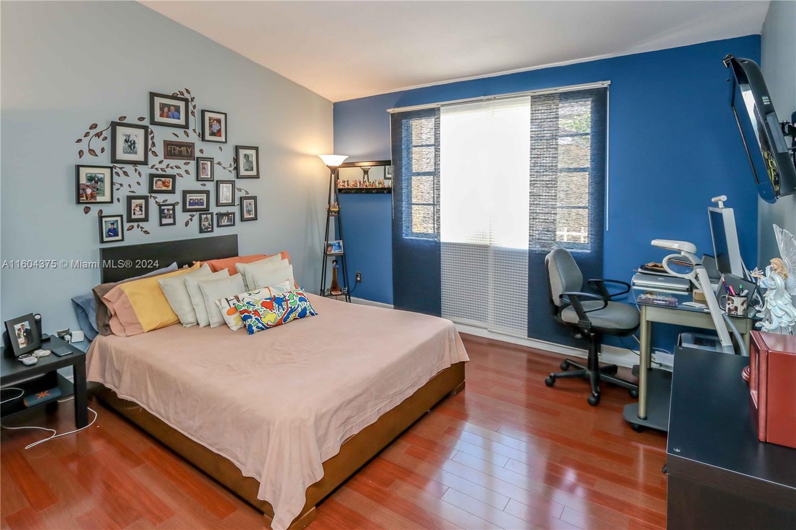 15253 Southwest 111th Street Miami, FL 33196 - Photo 12 of 32 a bedroom with a bed and a table in it