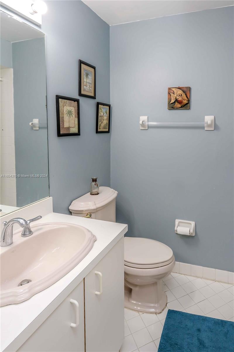 15253 Southwest 111th Street Miami, FL 33196 - Photo 15 of 32 a bathroom with a sink a toilet and mirror
