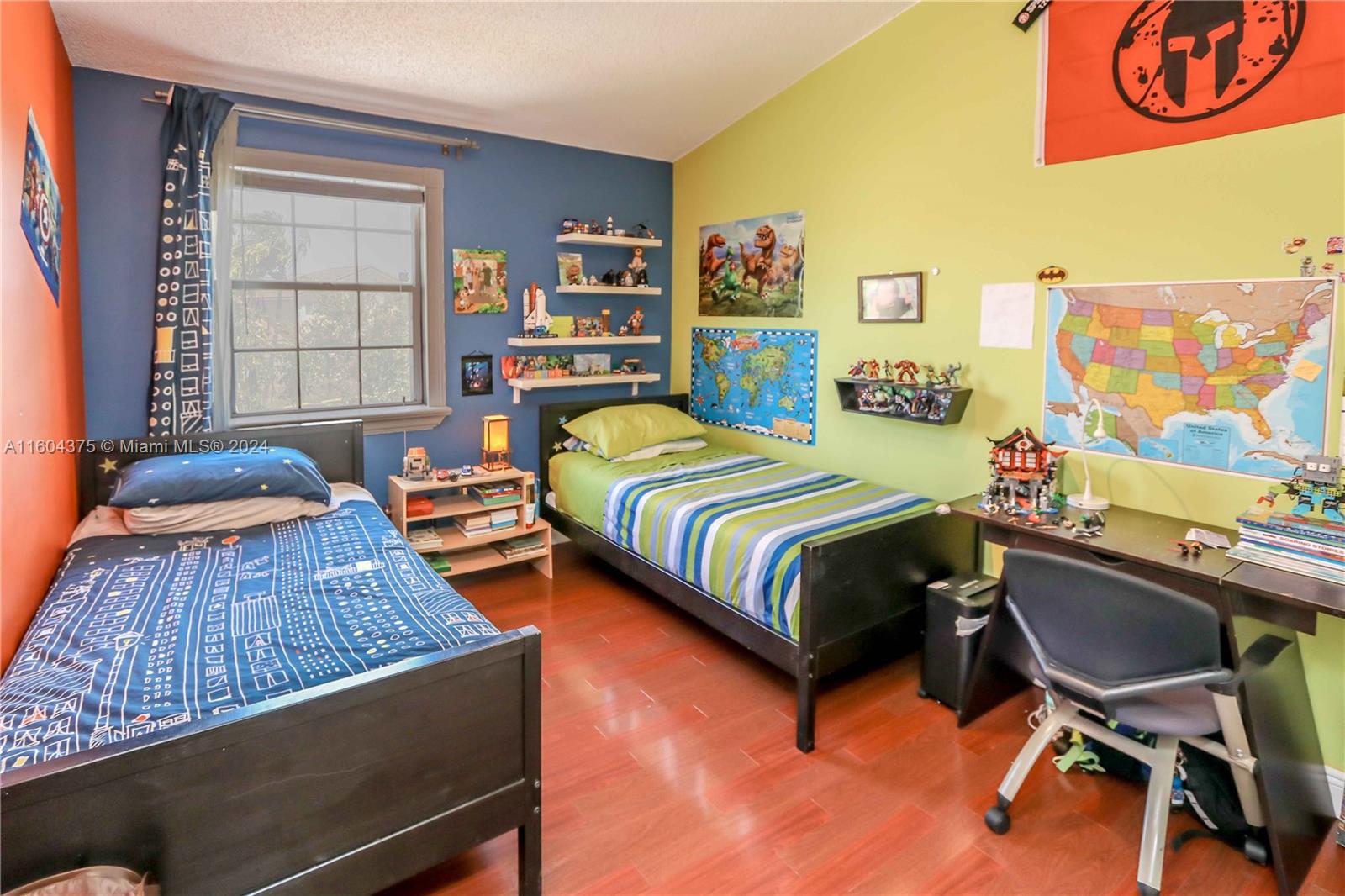 15253 Southwest 111th Street Miami, FL 33196 - Photo 19 of 32 a bedroom with a bed and a desk