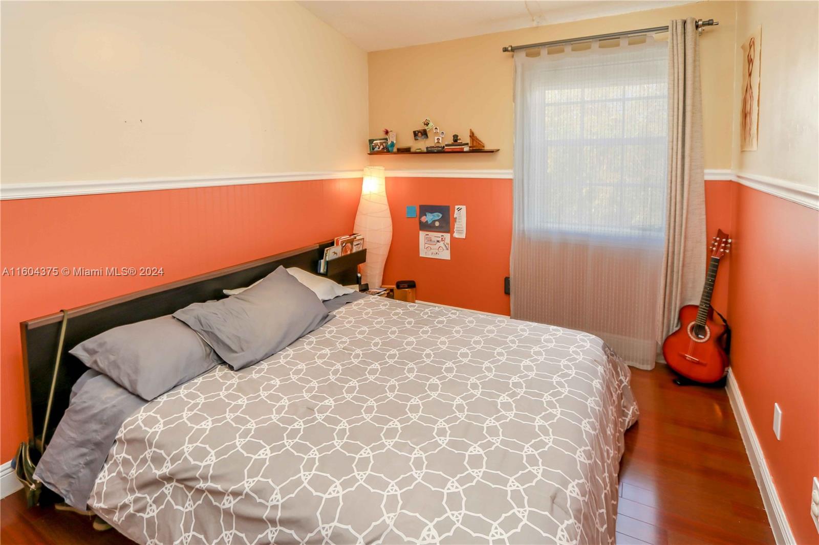 15253 Southwest 111th Street Miami, FL 33196 - Photo 21 of 32 a bedroom with a bed and a lamp with window