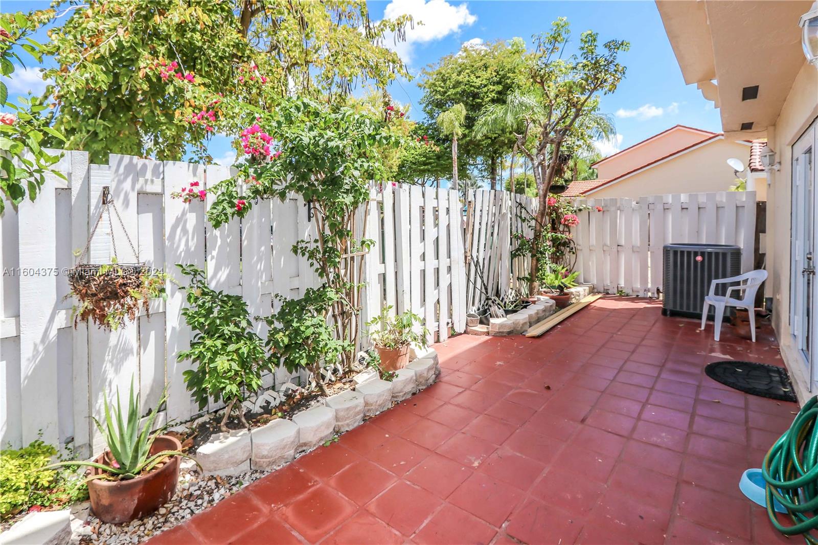 15253 Southwest 111th Street Miami, FL 33196 - Photo 3 of 32 a entryway view with a garden