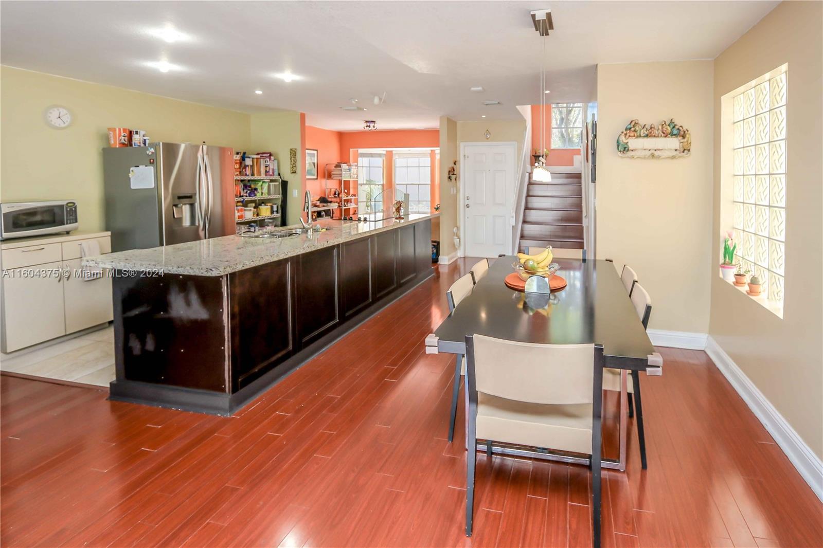 15253 Southwest 111th Street Miami, FL 33196 - Photo 6 of 32 a living room with stainless steel appliances kitchen island hardwood floor and a large window