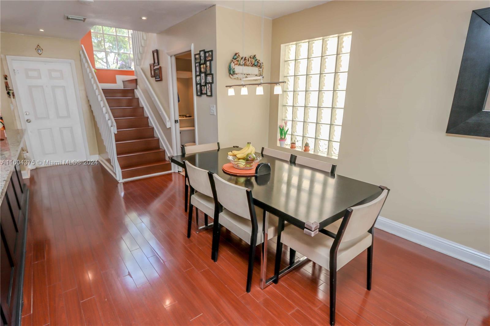 15253 Southwest 111th Street Miami, FL 33196 - Photo 7 of 32 a view of a dining room with furniture and wooden floor