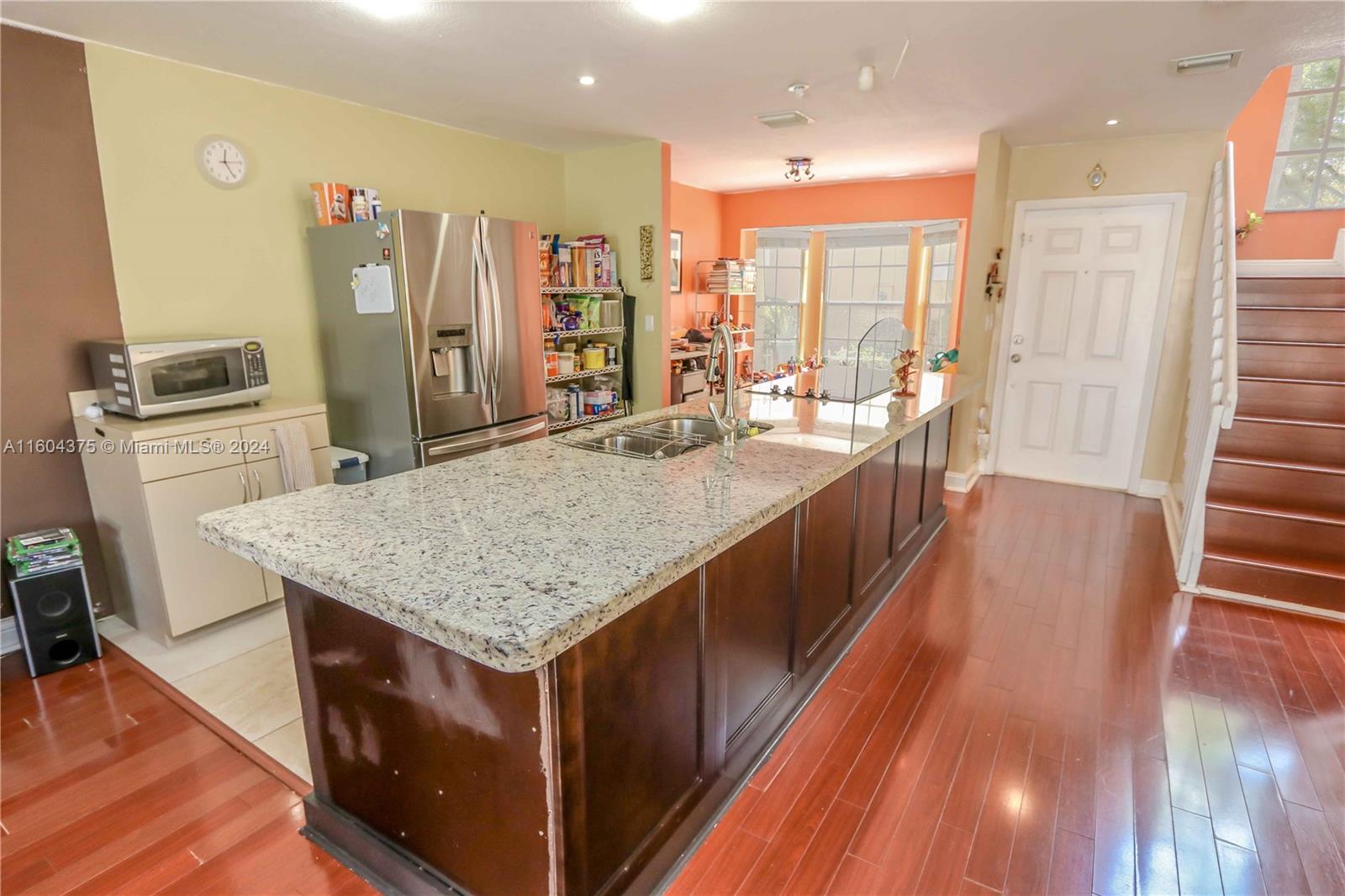 15253 Southwest 111th Street Miami, FL 33196 - Photo 8 of 32 a kitchen with stainless steel appliances granite countertop a lot of counter space and wooden floors