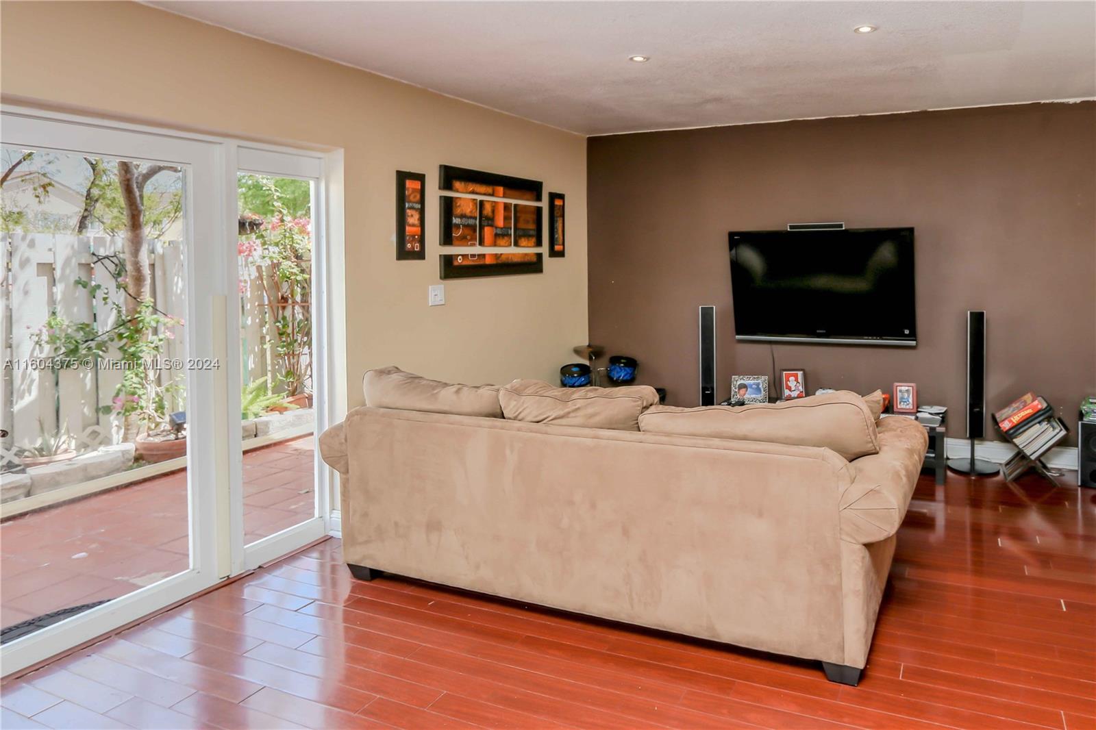 15253 Southwest 111th Street Miami, FL 33196 - Photo 9 of 32 a living room with furniture and a flat screen tv
