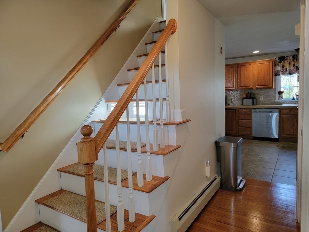2 Ivy Lane Rutland, MA 01543 - Photo 11 of 34 a view of entryway and kitchen with wooden floor