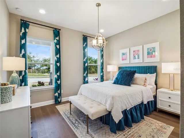 a bedroom with a large bed and a window