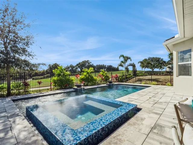 a view of a swimming pool with a lounge chairs