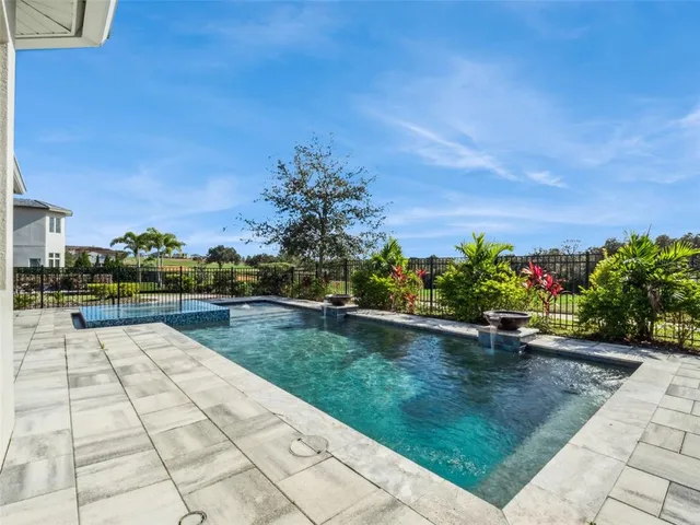 a view of swimming pool with outdoor seating and plants