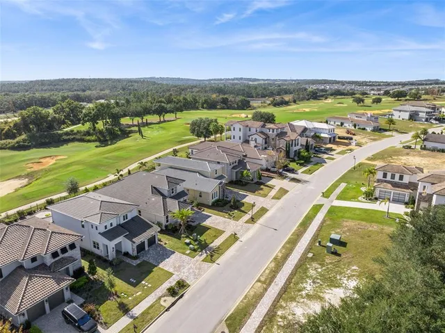 an aerial view of residential building with outdoor space and ocean view